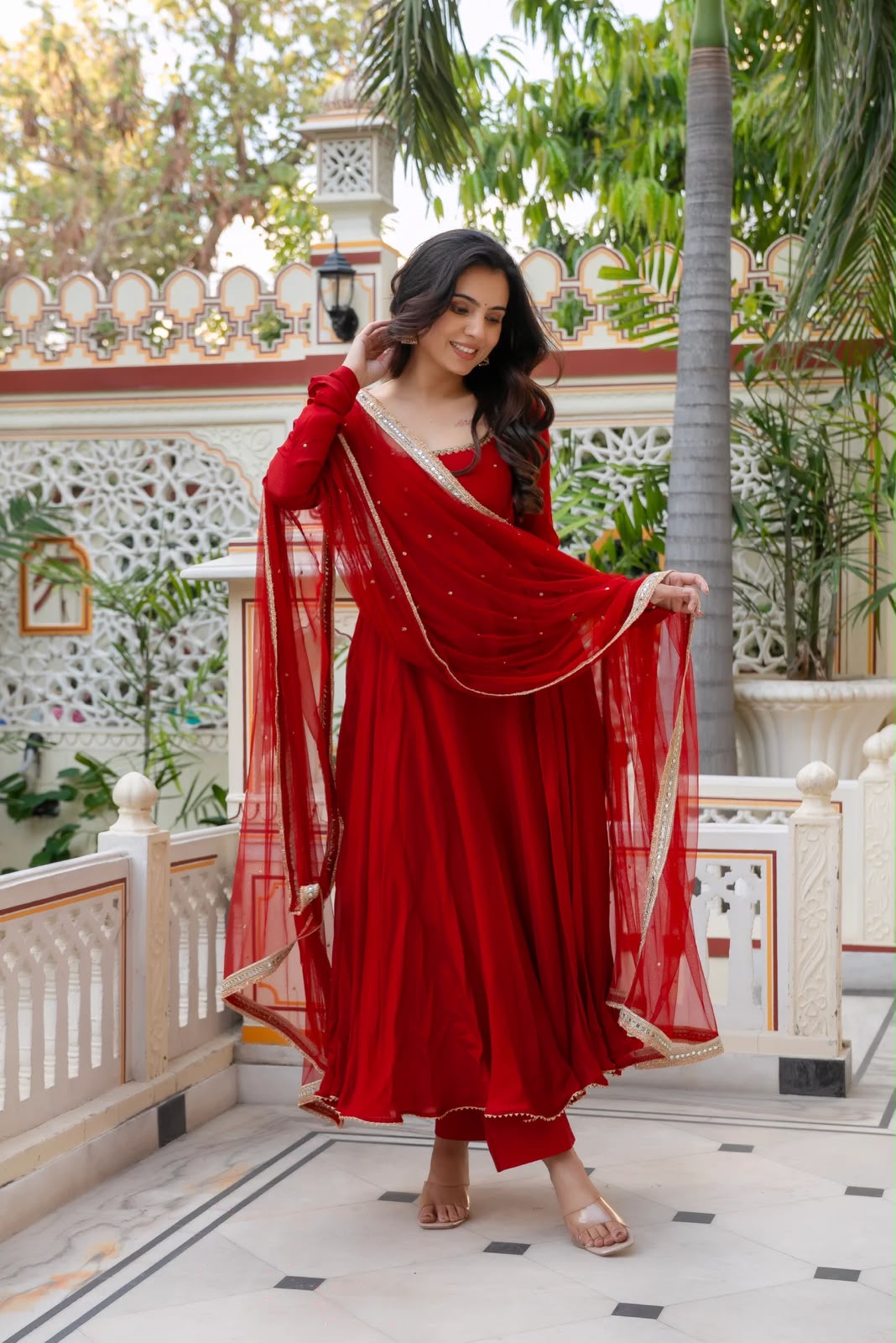 Model in red Anarkali full length outdoor